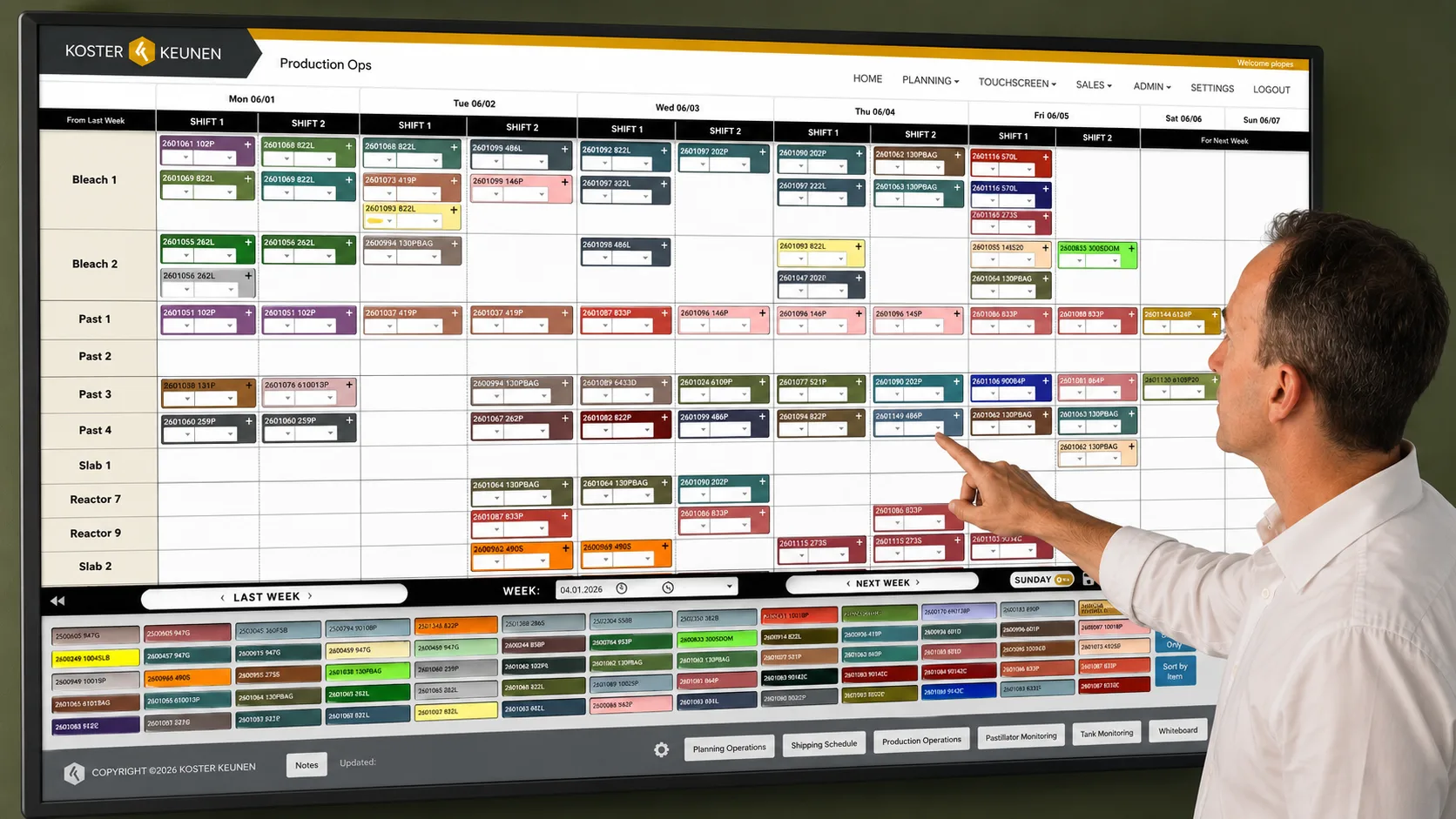 Operator interacting with a large VUE production operations touchscreen